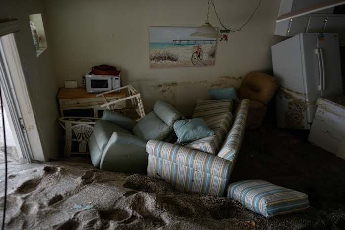 Enkele meters zand vult een appartement na de passage van de orkaan Milton, bij YCA Vacation Rental in Venetië, Florida, vrijdag 11 oktober 2024. (AP Photo/Rebecca Blackwell)