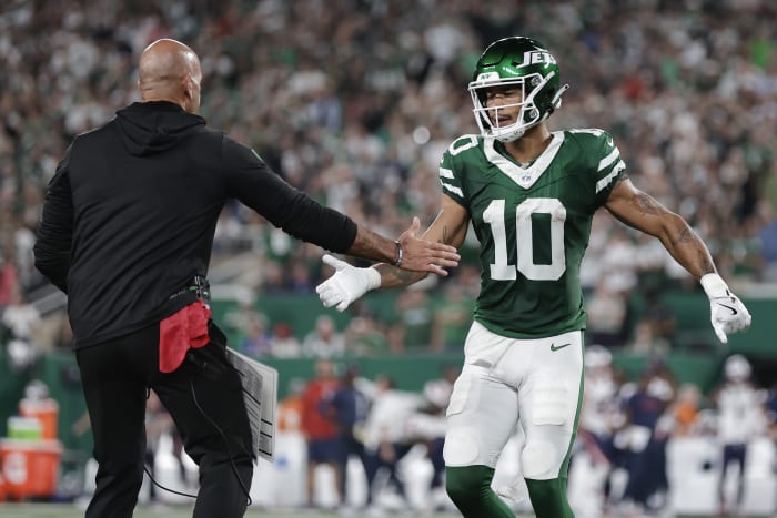 New York Jets wide receiver Allen Lazard (10) wordt gefeliciteerd door New York Jets-hoofdcoach Robert Saleh nadat Lazard een touchdown scoorde tegen de New England Patriots tijdens het eerste kwart van een NFL-voetbalwedstrijd, donderdag 19 september 2024, in East Rutherford, NJ (AP foto/Adam Hunger)
