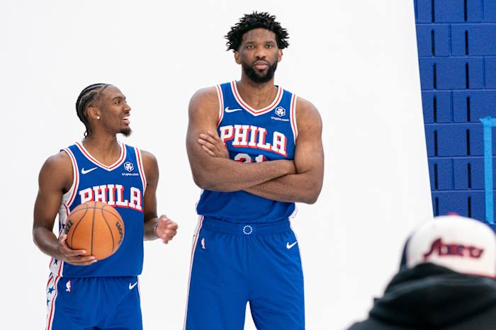 Tyrese Maxey van de Philadelphia 76ers, links, reageert terwijl hij poseert met Joel Embiid, rechts, voor foto's tijdens de mediadag van het NBA-basketbalteam, maandag 30 september 2024, in Camden, NJ. (AP-foto/Chris Szagola)