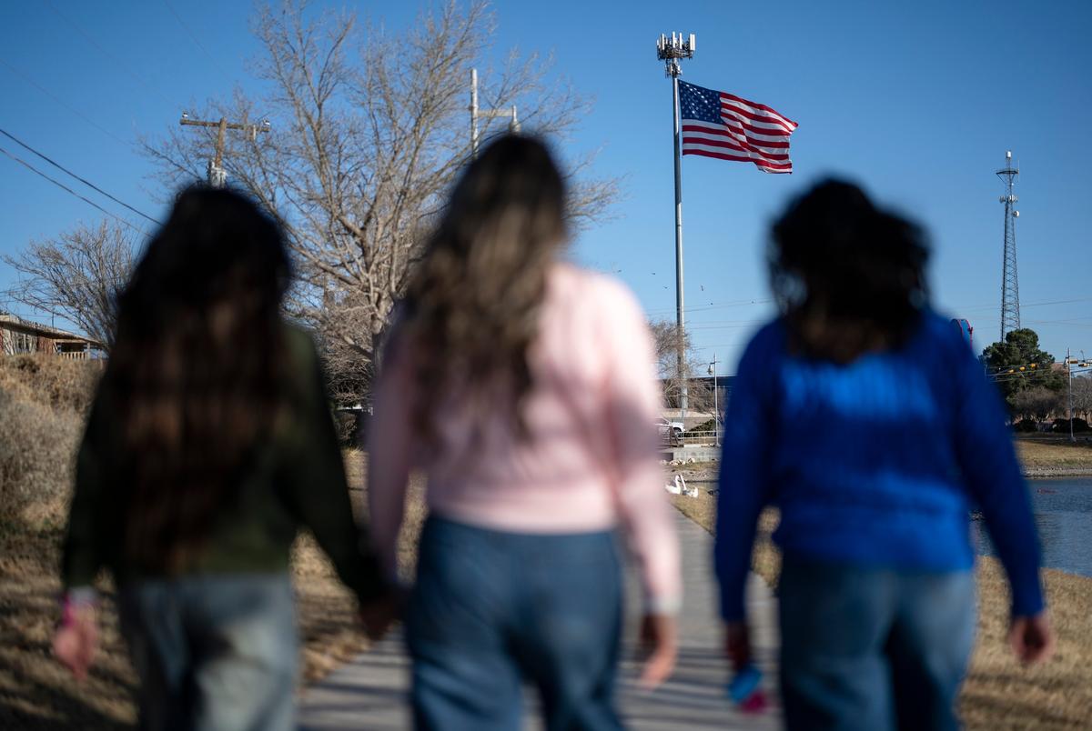 Miriam Guzmán, centrum, en haar dochters en hun hond, Asher, lopen op zaterdag 15 februari 2025 door Memorial Gardens Park in Odessa.