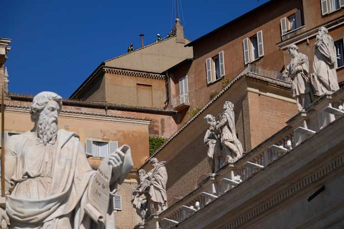 Vaticaanse brandweerlieden installeren een schoorsteen op het dak van de Sixtijnse kapel voor de pauselijke verkiezing
