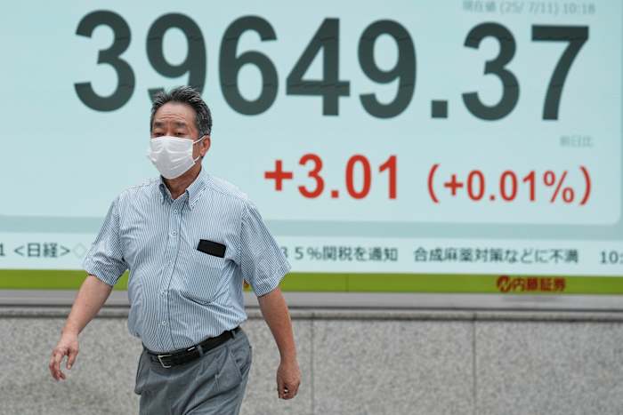 Aziatische aandelen zijn gemengd nadat Wall Street hoger wordt gesloten en rand naar meer records