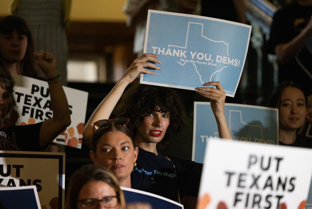 Een menigte houdt borden op terwijl vertegenwoordigers het Texas -huis binnenlopen op 18 augustus 2025. Texas Democraten verlieten de staat om op nationaal niveau herverdeling te bestrijden en na twee weken terug te keren om het werk in de staat te hervatten.